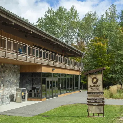 Exterior of Lakeside Center in the spring surrounded by trees and greenery.