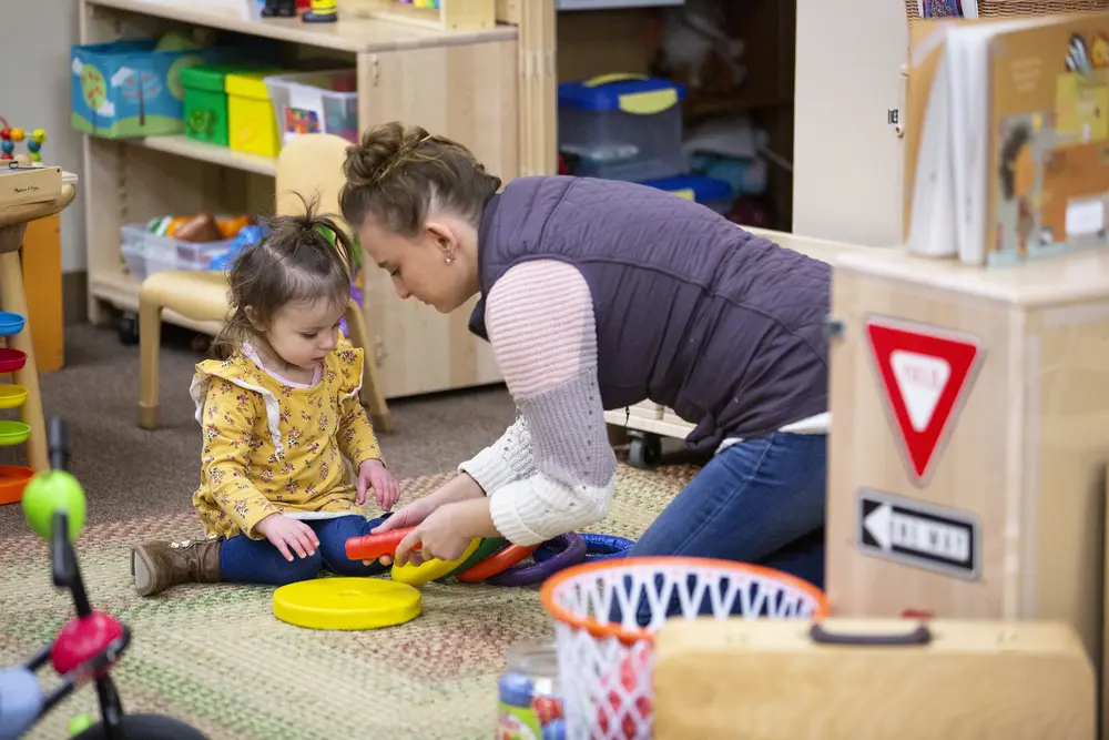 early childhood ed student playing with child