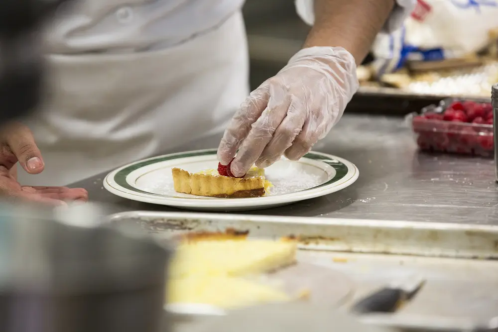 Culinary student finishing dessert