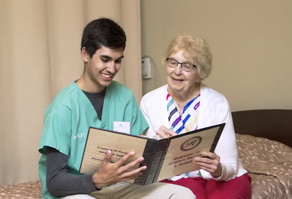 Nursing assistant student with patient at rehab facility.
