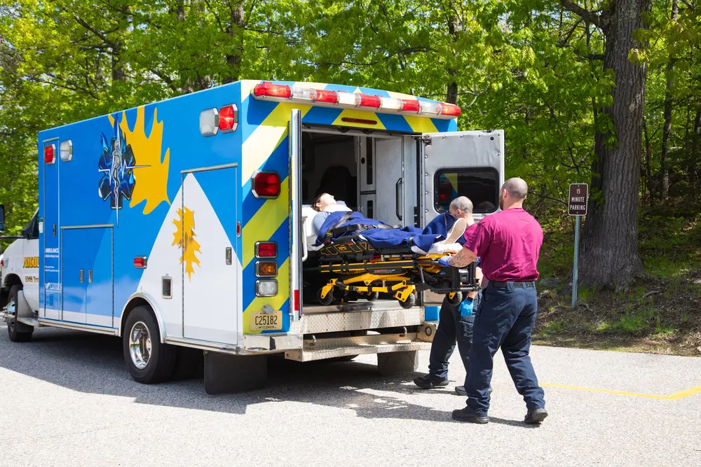 Emergency Response students removing a patient from the ambulance on a stretcher.