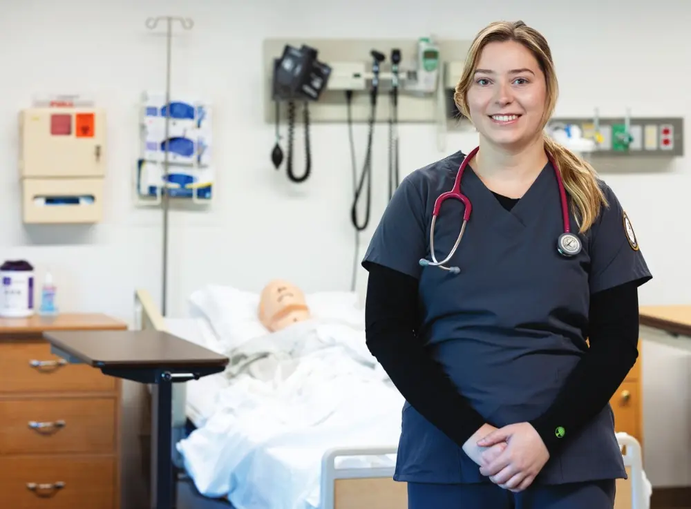 Makayla Mahler, a nursing student, smiling in a classroom.