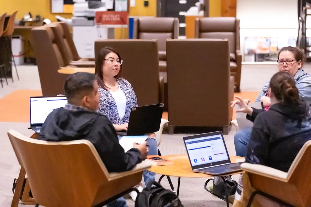 Tribal Business Management students discussing topics in student lounge.