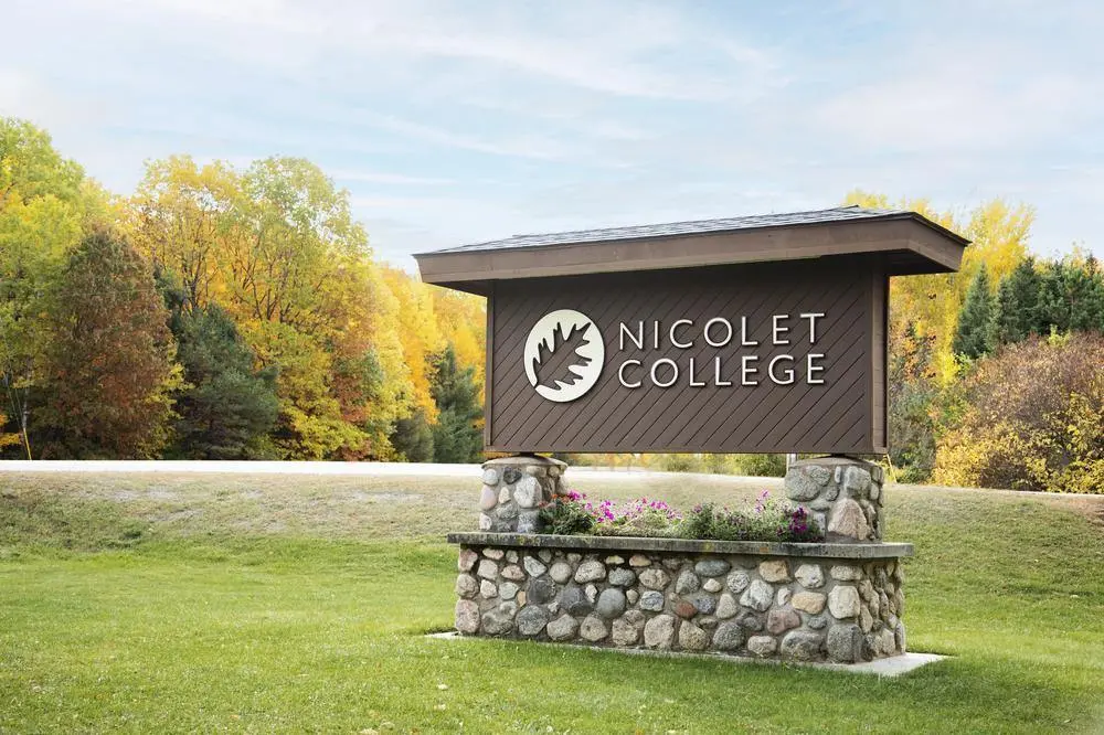 The Nicolet College sign at campus entrance in fall.