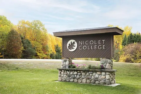The Nicolet College sign at campus entrance in fall.