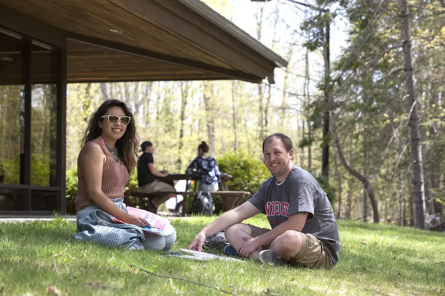 students sitting on lawn