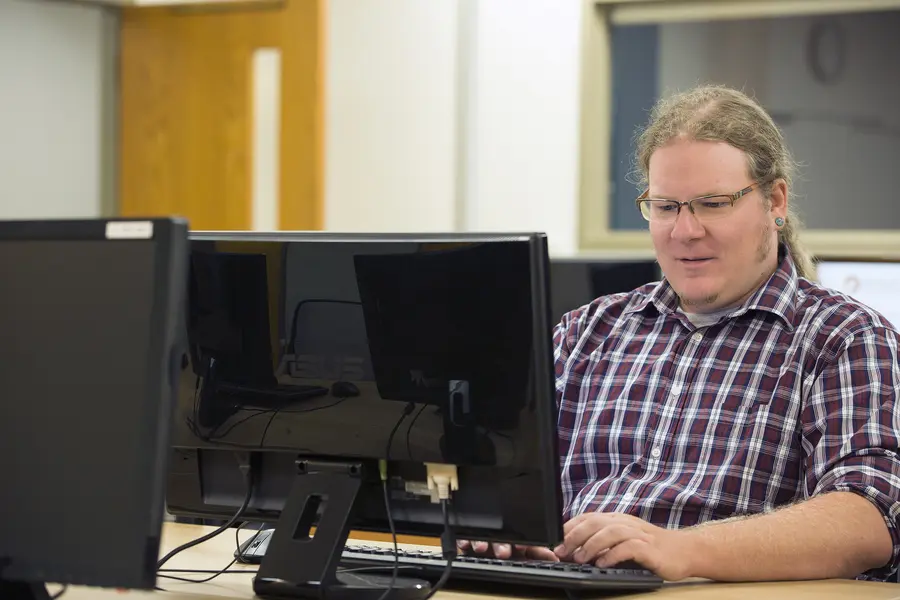 student at computer diagnosing issues