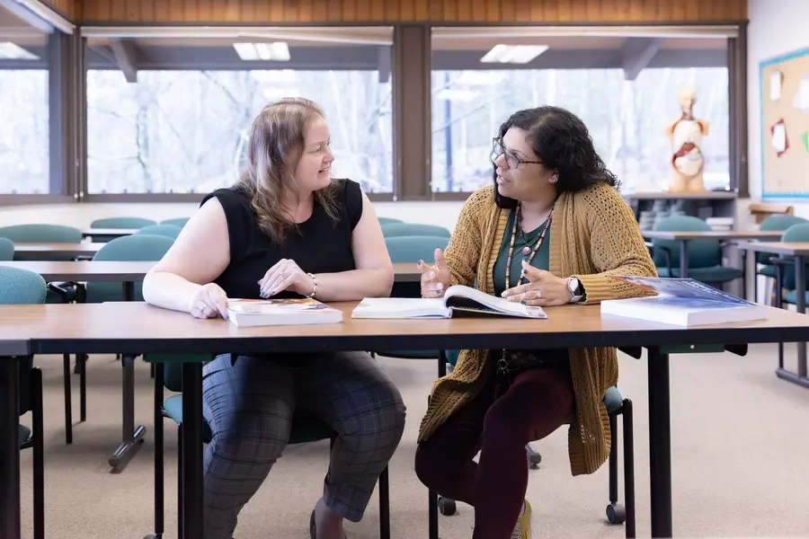 Instructor working with a Human Services student in a classroom.