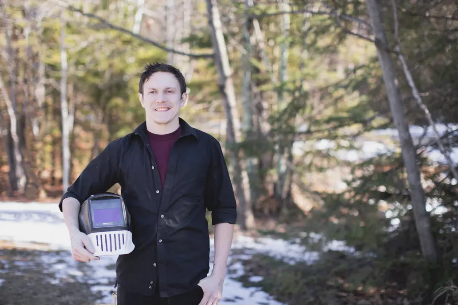 2024 Foundation Ambassador standing outside holding welding helmet